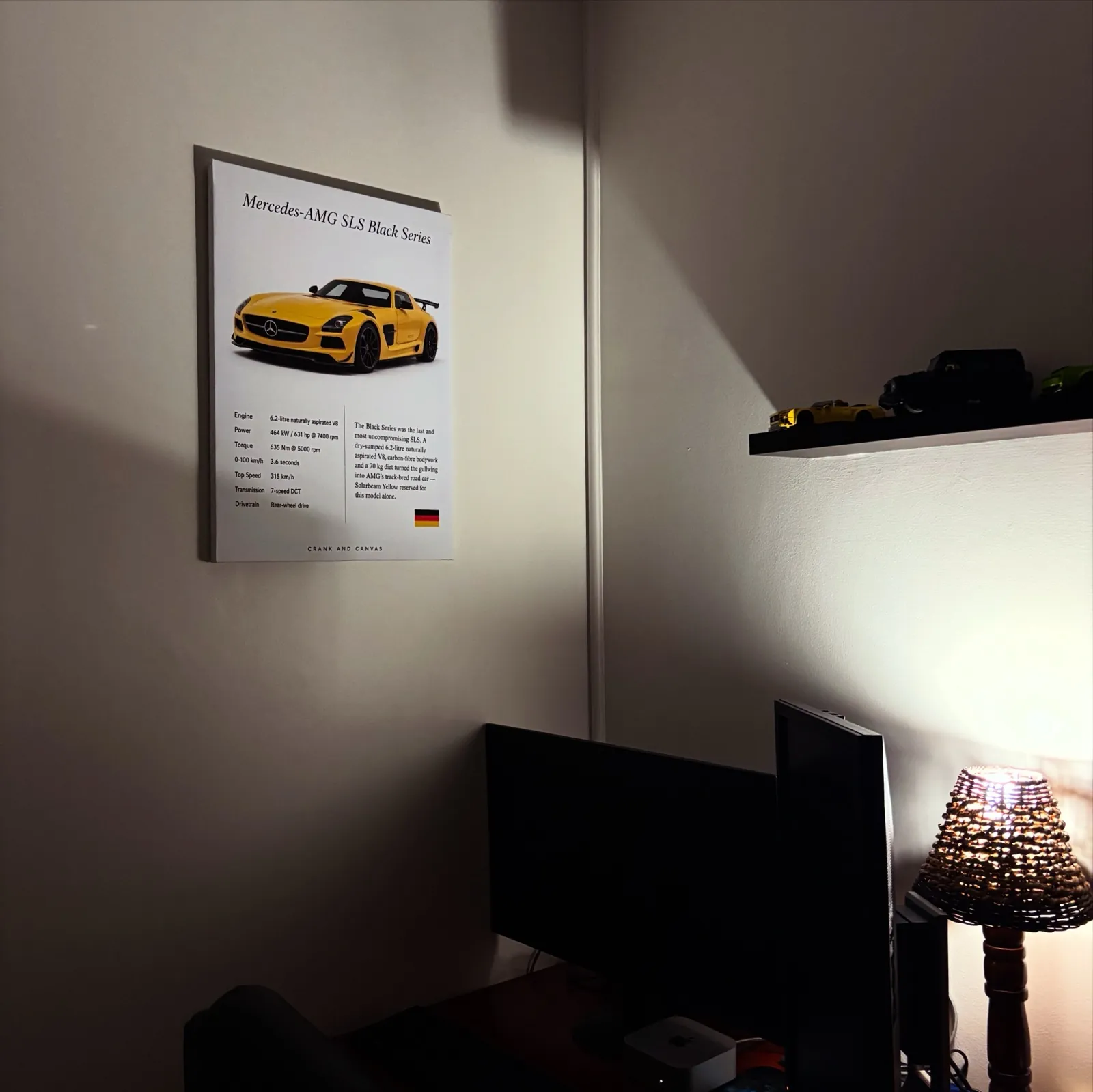 Mercedes-AMG SLS Black Series canvas above a desk in a lamplit study